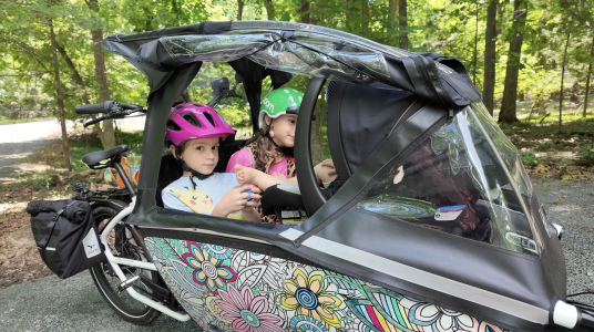 urban arrow family cargo bike with rain cover.png